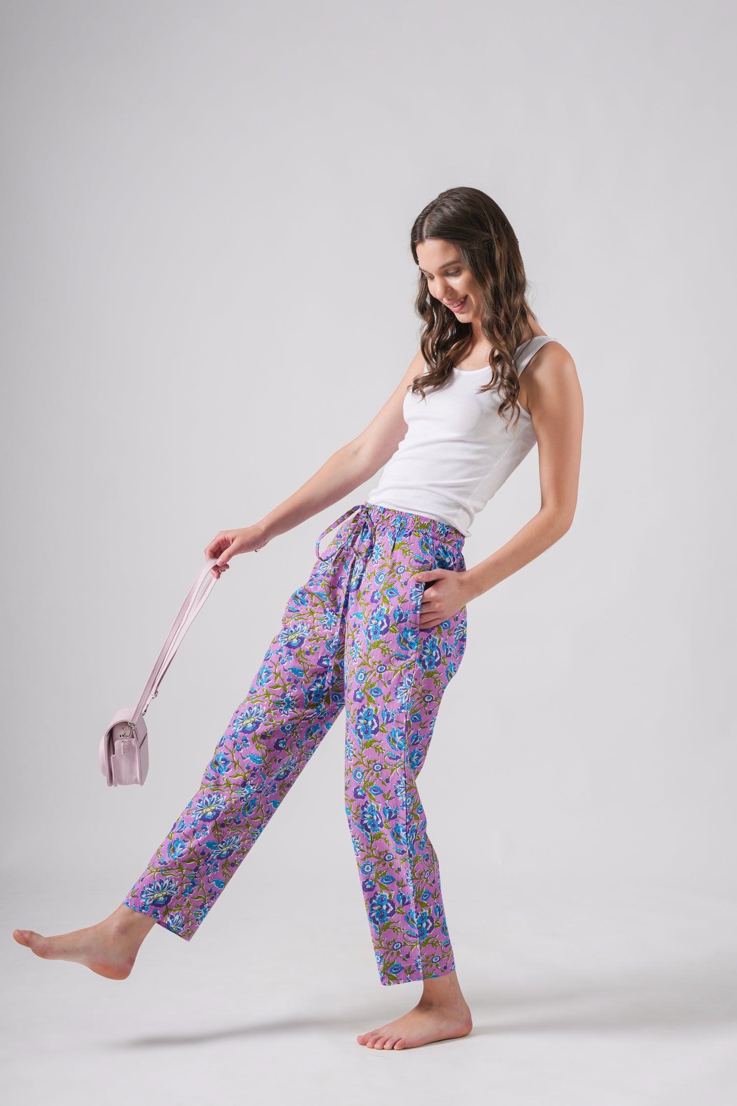 Handmade cotton sleep pants for women with an elastic waistband, functional pockets, and trendy blue floral design on lavender — perfect for a cotton anniversary gift or lounging in style.