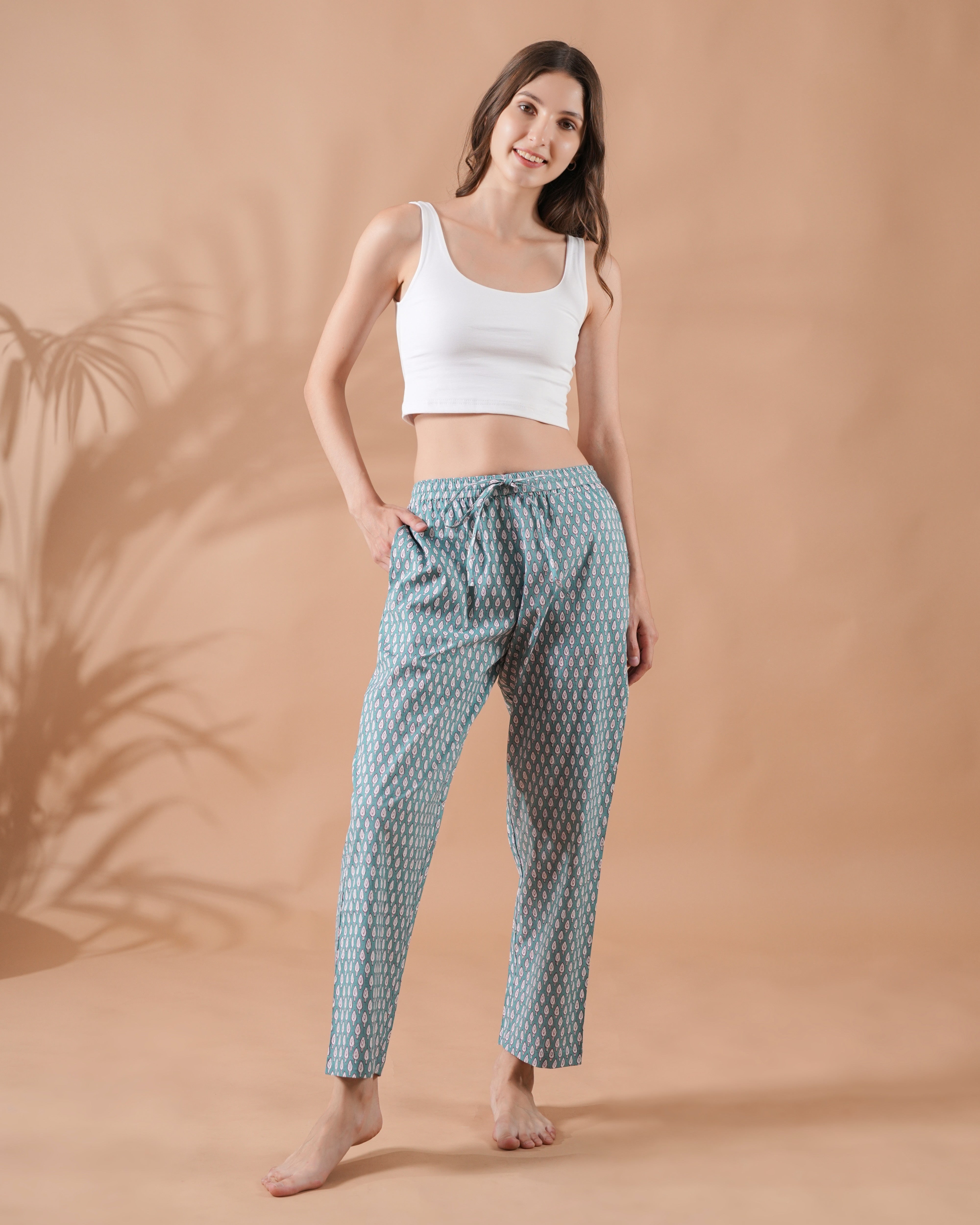 Vibrant floral print pajama pants with red blooms on breathable green cotton, designed with a flexible drawstring waist and side pockets—perfect for boho sleepwear sets or unique 2nd anniversary gift ideas.
