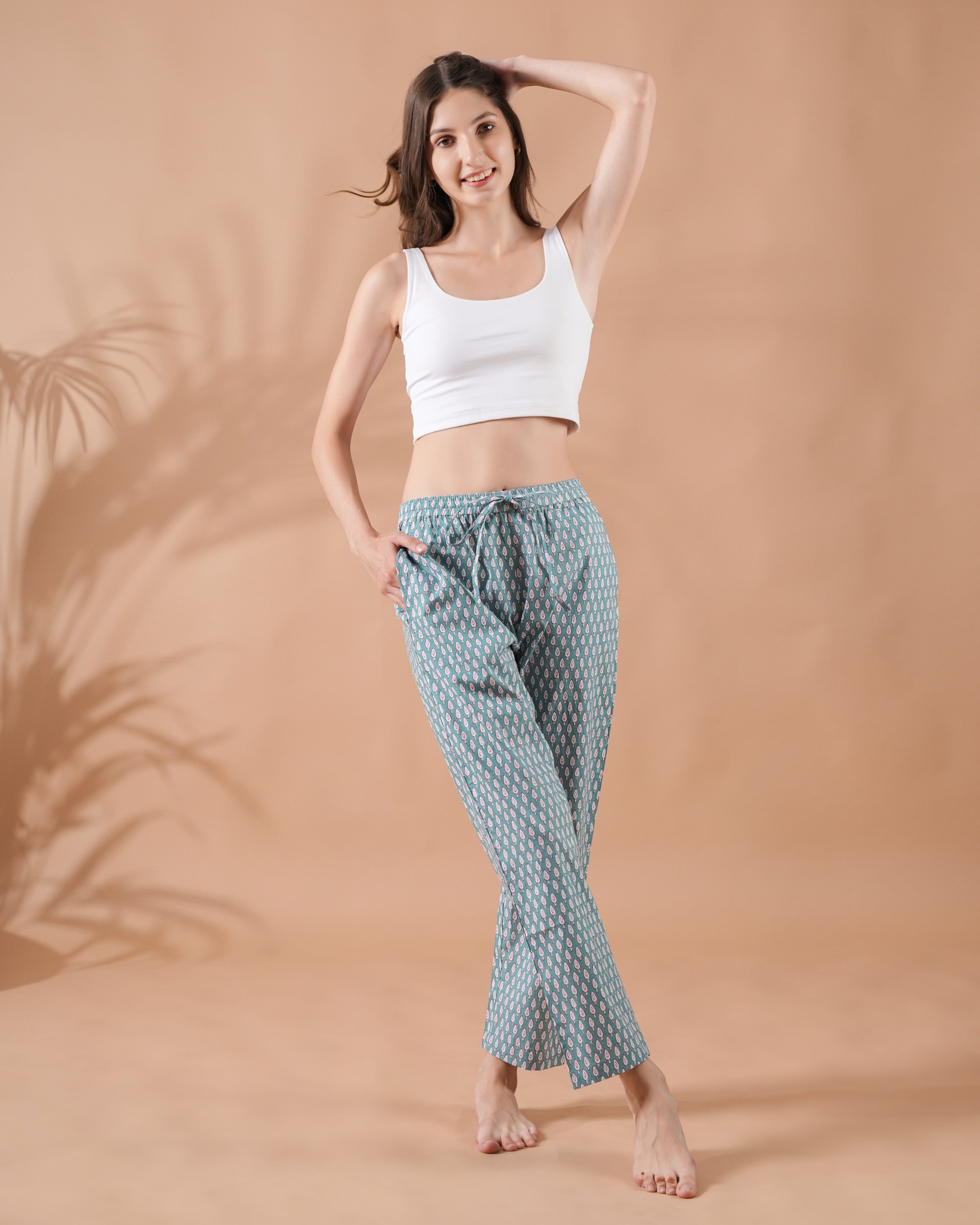 Floral sleep pants for women made of lightweight 100% cotton, featuring red flowers on green, with elastic waistband and drawstring—great for spring gifts or boho wardrobes.