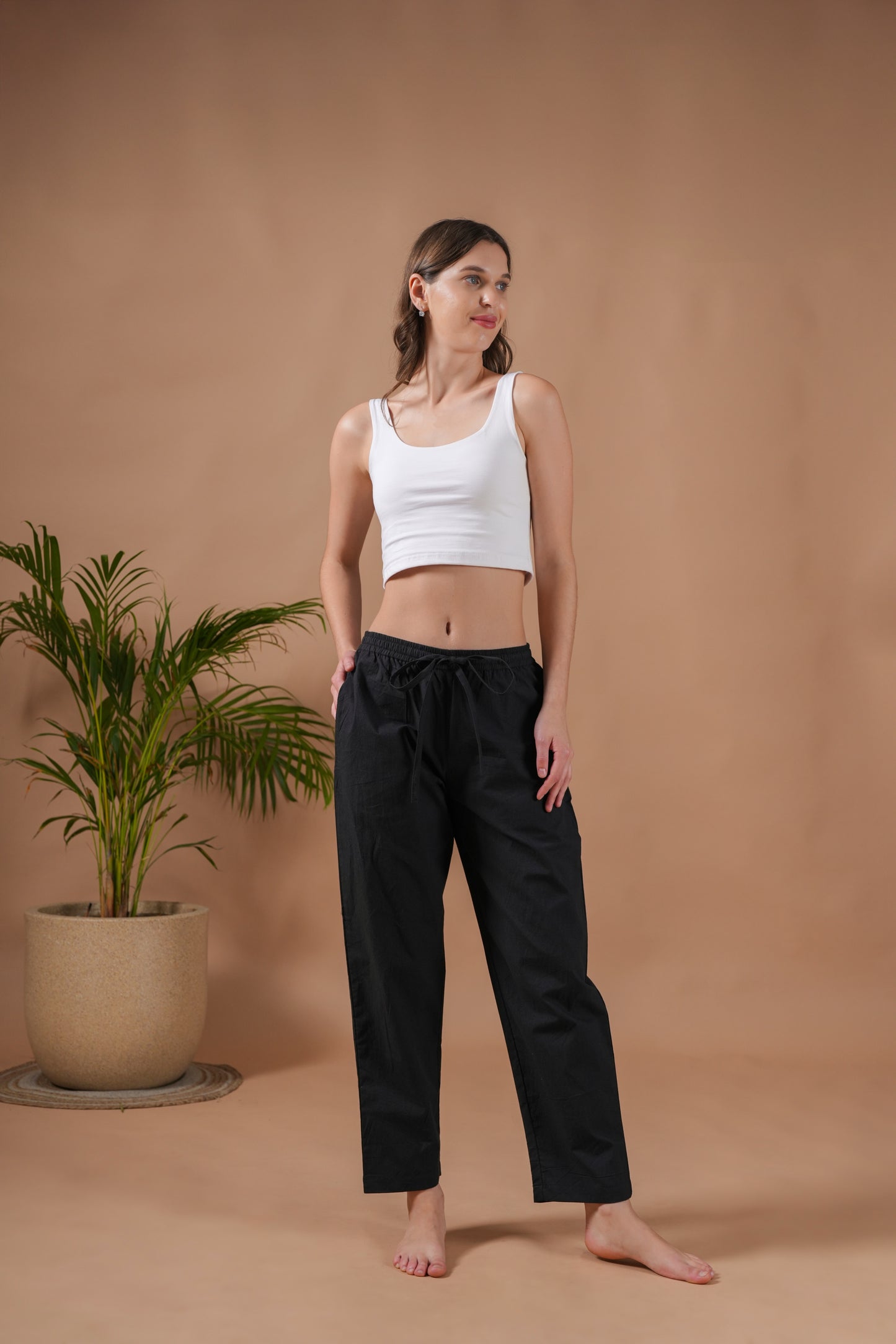 Modern and lightweight black cotton trousers for women made from poplin, featuring an elastic waistband, drawstring, and pockets—ideal for lounge & sleepwear or as stylish punk pants.