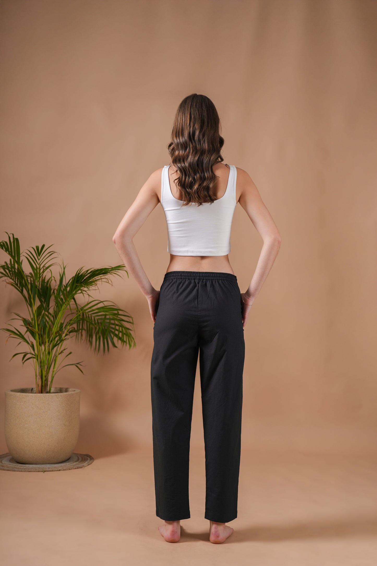 Loose and comfy solid black cotton poplin trousers for women with elastic waist and deep pockets—versatile pull-on pants for lounging or unique nature-inspired gift boxes.