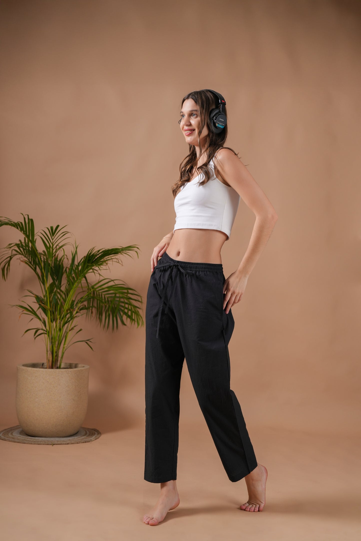 Soft and breathable 100% cotton black lounge pants with a loose silhouette, elastic waist, and pockets—perfect for relaxing, meditating, or giving as a traveler’s gift.