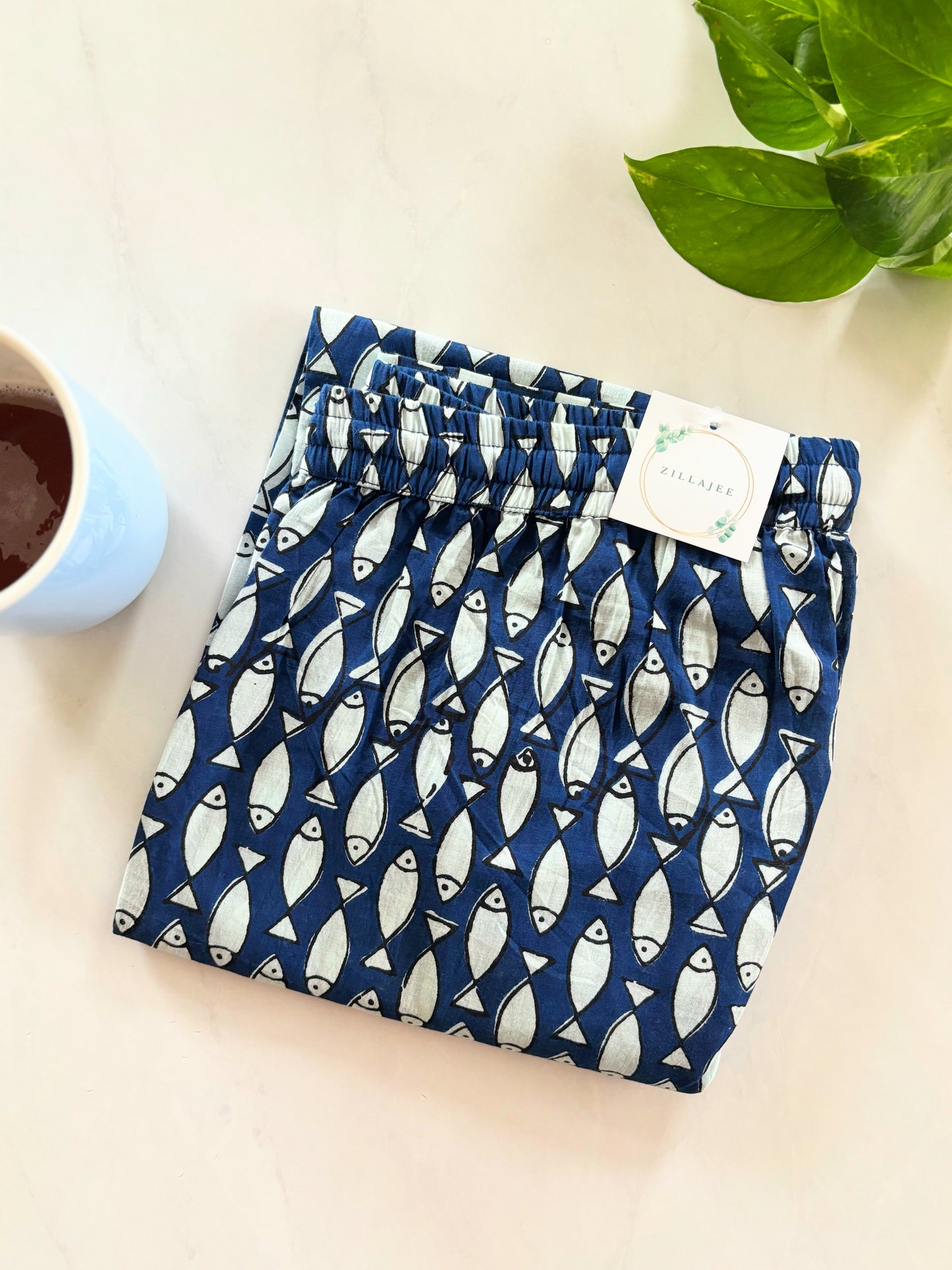 Comfortable and loose cotton pants for women with pockets – breathable and stylish in a vibrant ocean print with white fish.