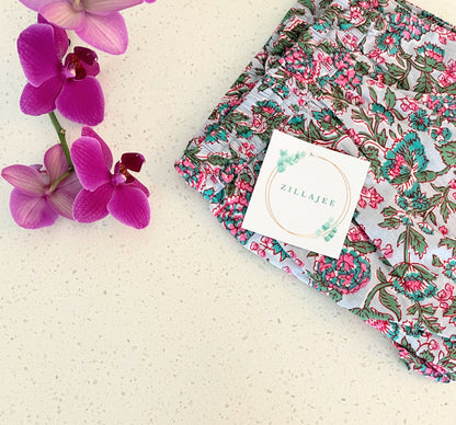 Breathable and soft cotton pajama bottoms for women, adorned with a delicate pink floral design on a gray base, ideal for relaxing or bedtime.