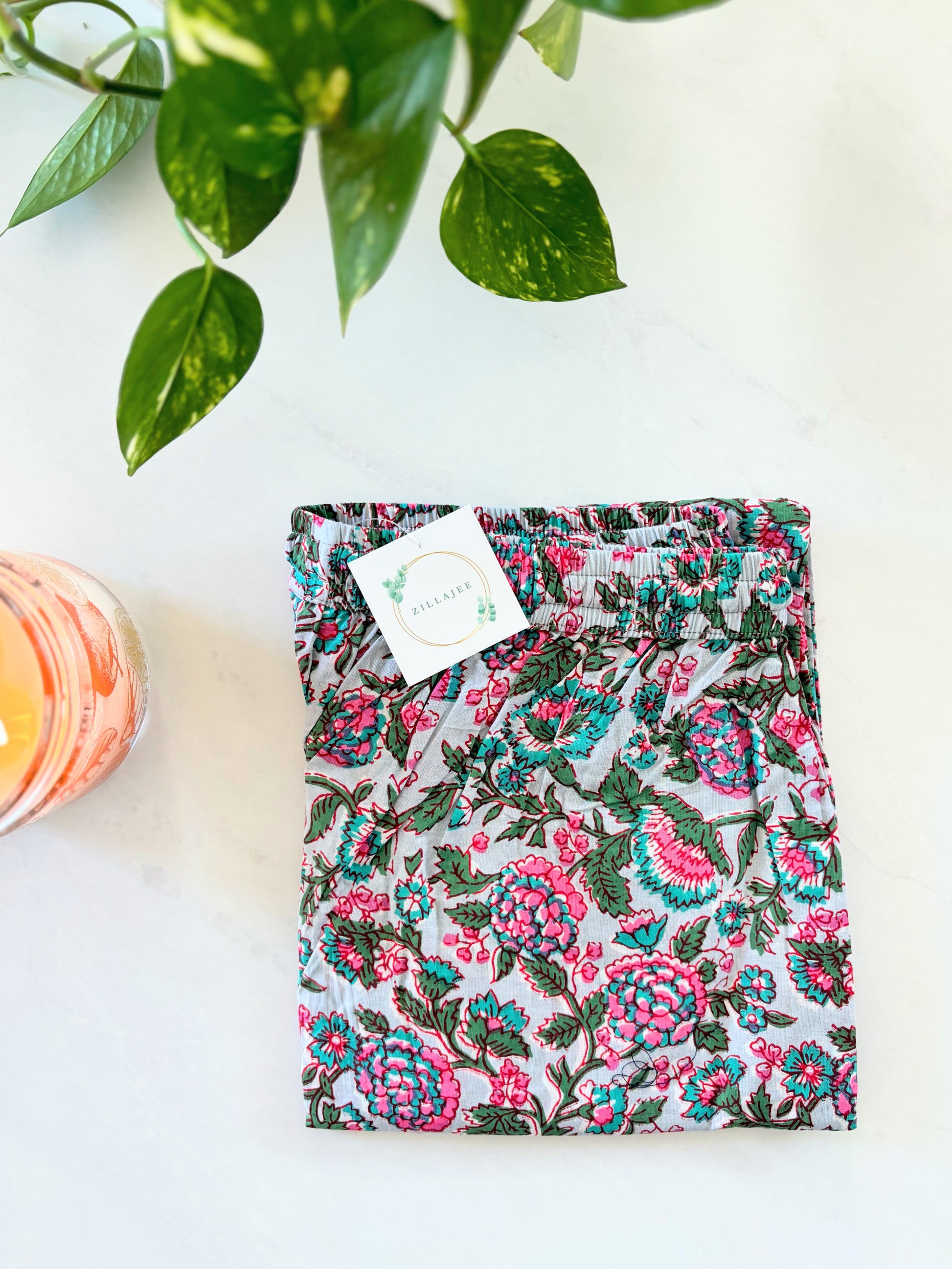 Floral print jammies for women, featuring soft, breathable cotton fabric with pink flowers on gray, perfect for bedtime or casual lounging.