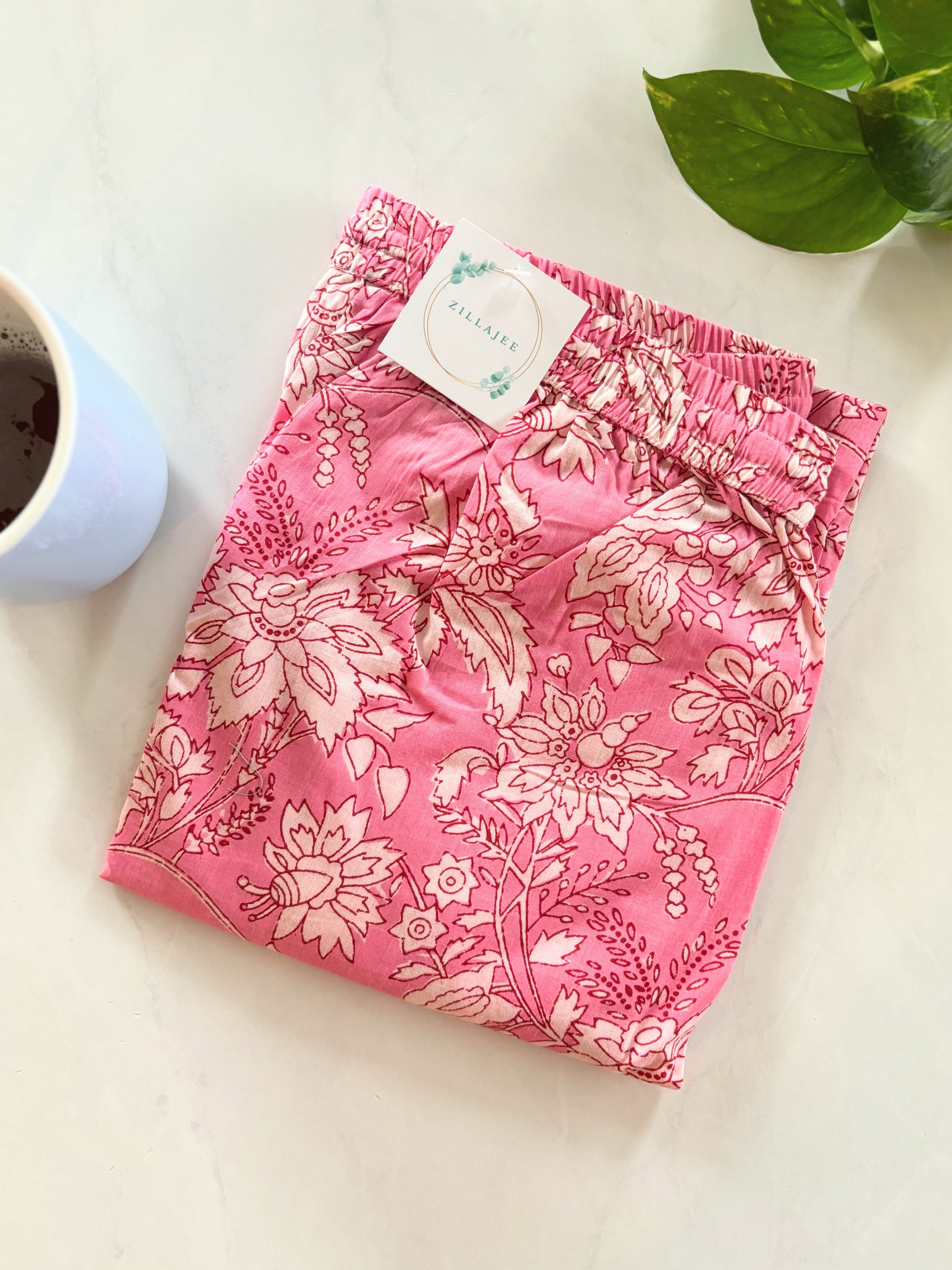 Soft and breathable pink lounge pants for women, with white flowers and a comfy elastic waistband