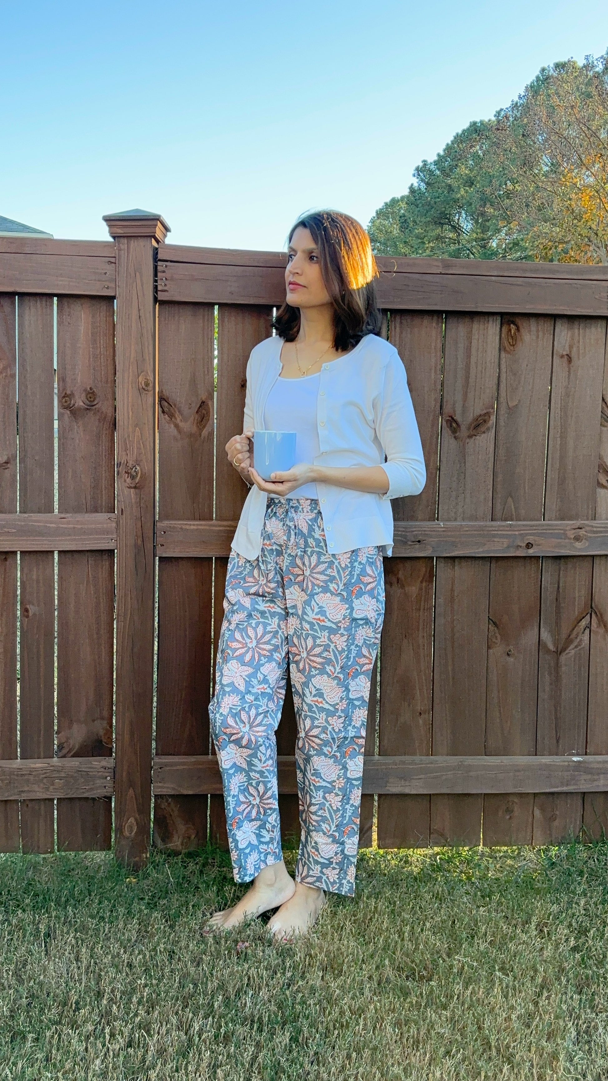 Modern cotton sleep pants for women with a drawstring waistband and relaxed fit, showcasing a bohemian orange floral print on gray.