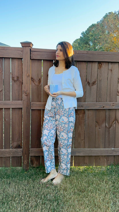 Modern cotton sleep pants for women with a drawstring waistband and relaxed fit, showcasing a bohemian orange floral print on gray.