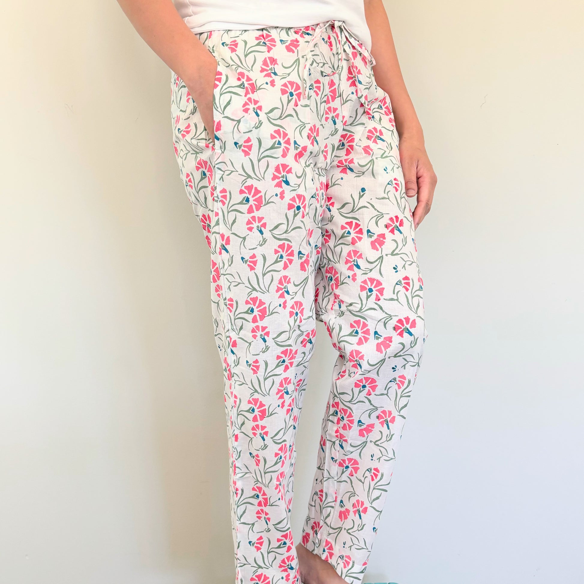 Handmade cotton pajama pants with pockets and a vibrant pink floral design, perfect for a comfy night in.