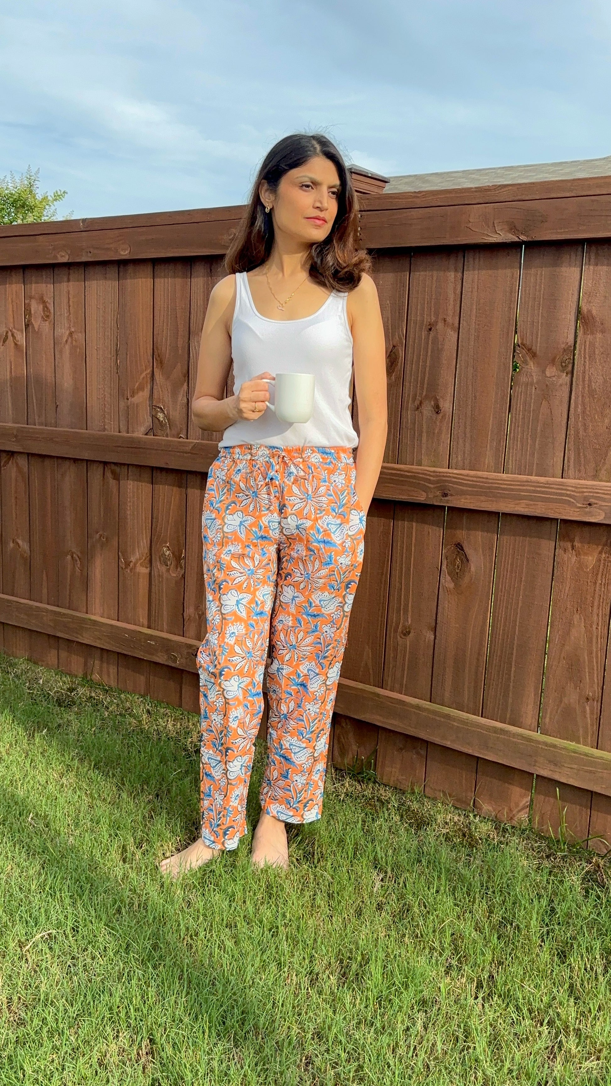 Soft, lightweight sleepwear for women, featuring pajama bottoms with an orange floral design on green, perfect for unwinding or sleeping.