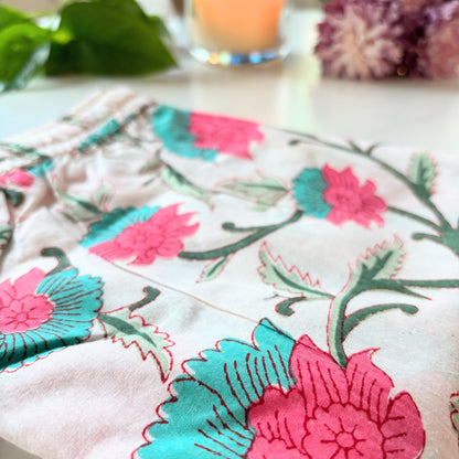 Tropical floral pajama pants for women, made from lightweight cotton in a bright pink and green flower print with a comfy relaxed fit.