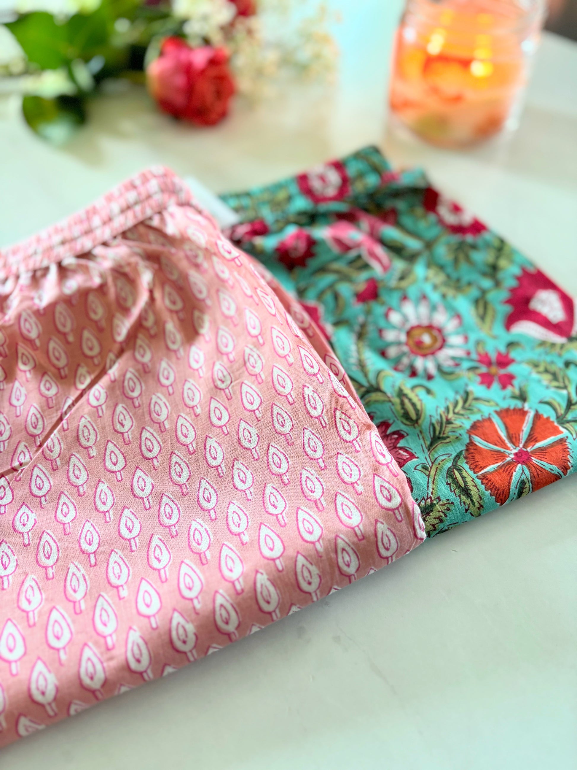 Set of 2 trendy pink floral pajama bottoms for women, featuring an elastic waistband and pockets, perfect for lounging or relaxing at home.
