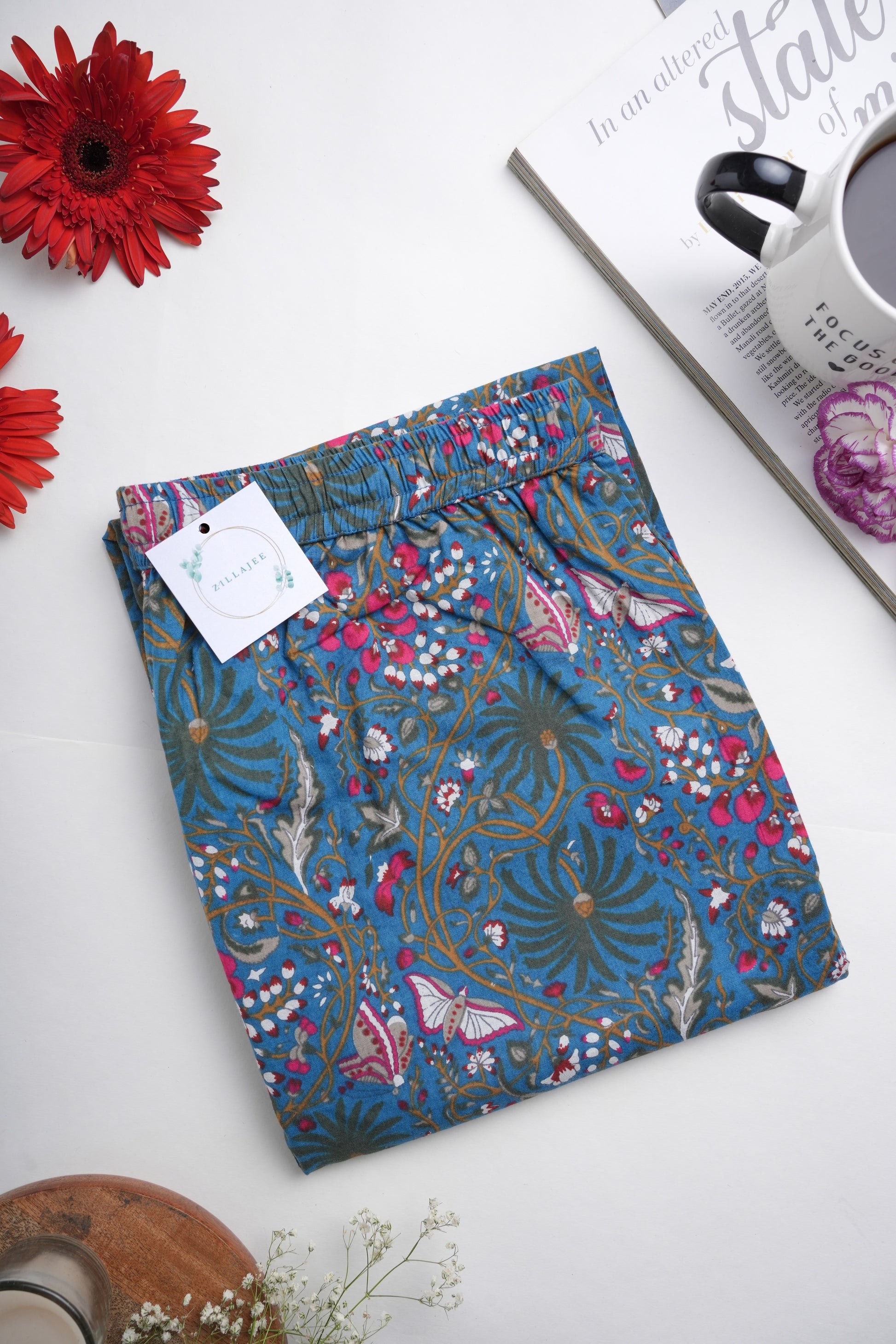 Tropical floral pajama pants with pockets and an elastic waistband, made from breathable cotton in dark blue with pink butterflies – a thoughtful menopause or bridal party gift.