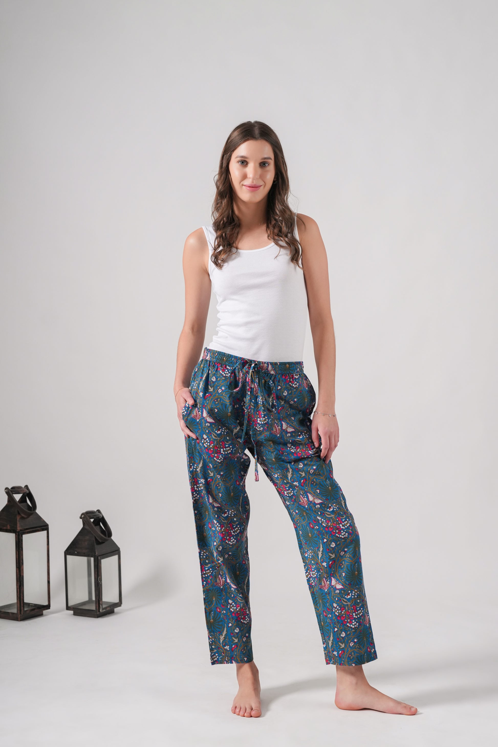 Unique handmade pajama pants with pink flowers and butterflies, featuring side pockets, a soft elastic waistband, and breathable cotton for sleep or casual lounging.
