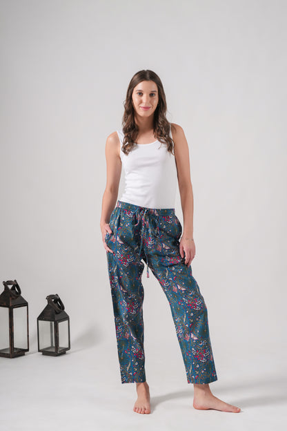 Unique handmade pajama pants with pink flowers and butterflies, featuring side pockets, a soft elastic waistband, and breathable cotton for sleep or casual lounging.