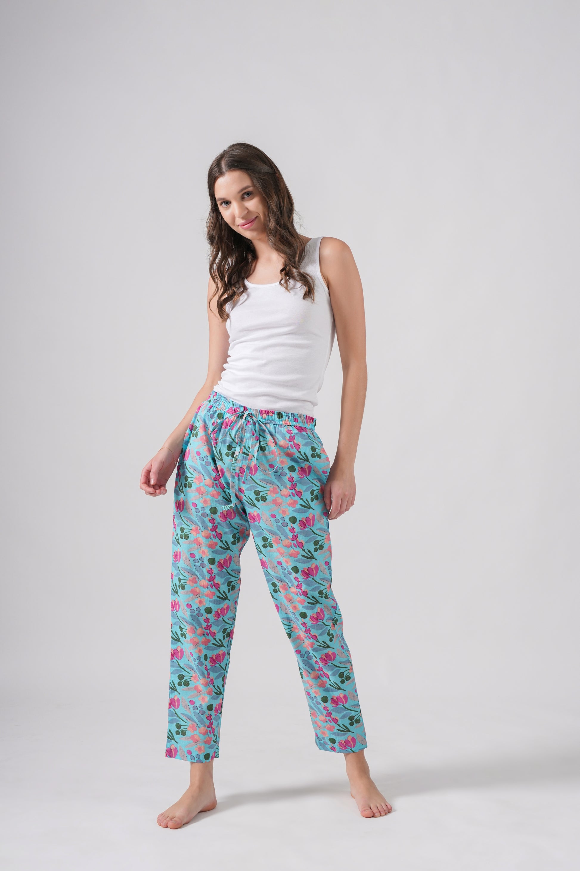 Pink floral cotton pajama pants for women with an elastic waistband, adjustable drawstring, and side pockets — unique handmade gift idea for 2nd anniversary or tropical sleepwear.