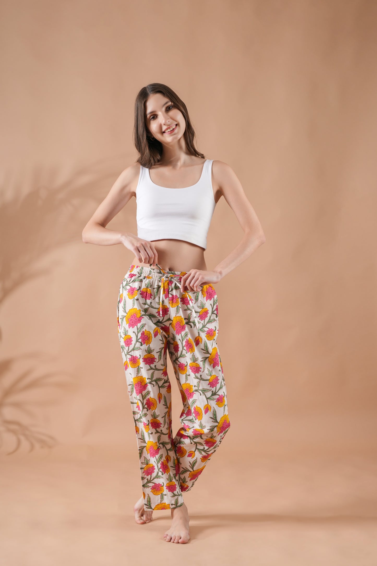 Breathable cotton pajama pants with pockets, pink and yellow flower design, and elastic waist — ideal bride getting ready outfit for a spring or summer wedding.