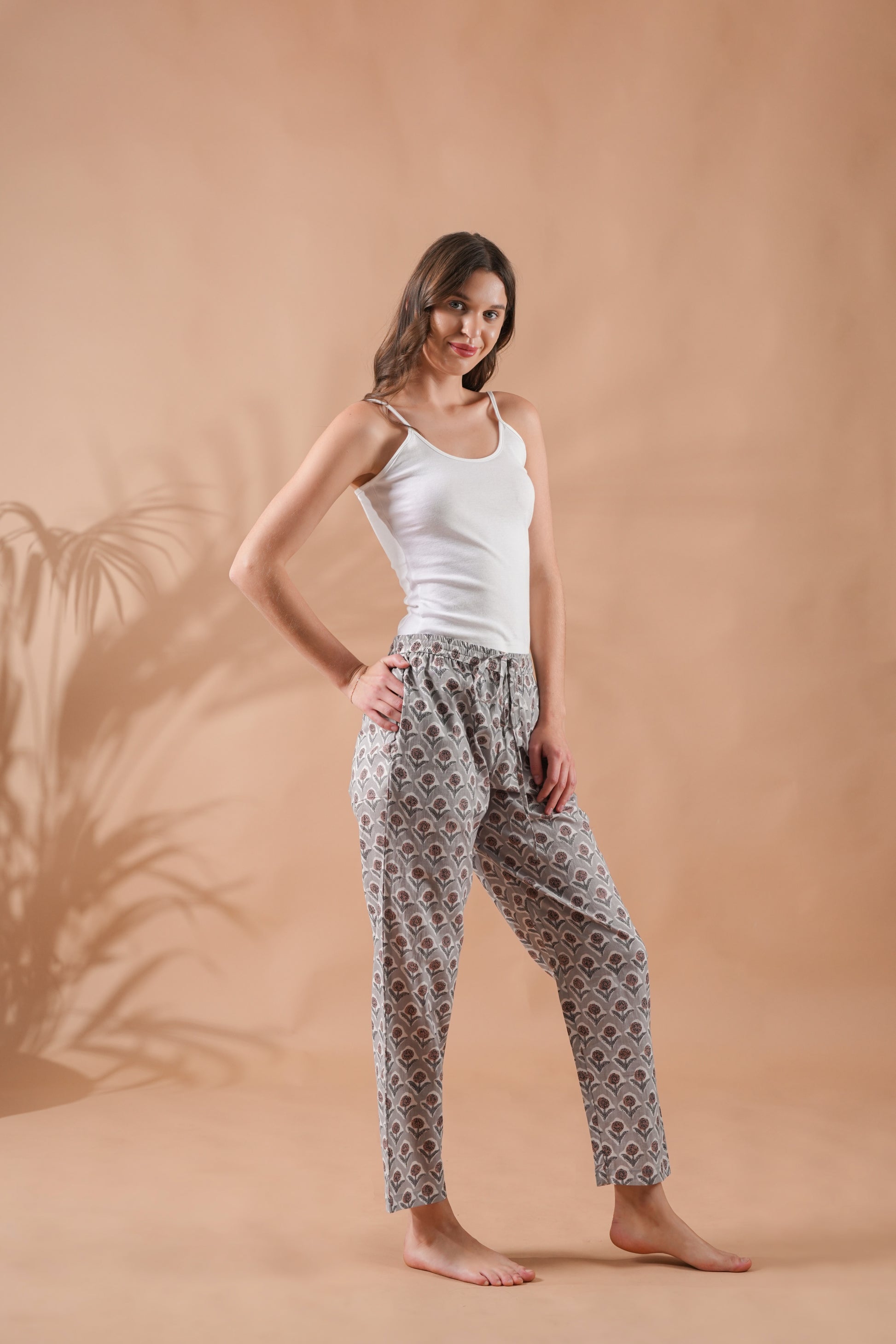 Soft and breathable 100% cotton lounge pants with modern brown floral print on gray fabric, complete with pockets and a relaxed elastic waistband — a thoughtful menopause gift idea or stylish sleepwear choice.