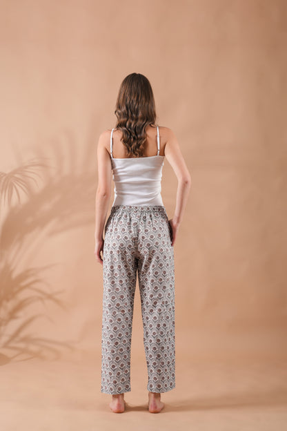 Breathable floral sleep pants for women in gray with warm brown flower accents, elastic waistband, adjustable drawstring, and deep pockets — a modern and versatile gift idea.