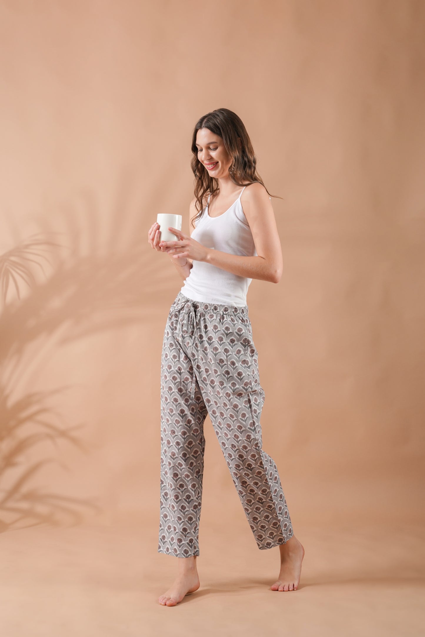Gray pj pants with nature-inspired brown flowers, breathable fabric, side pockets, and elastic waistband — perfect sleepwear for gifting or relaxing at home.
