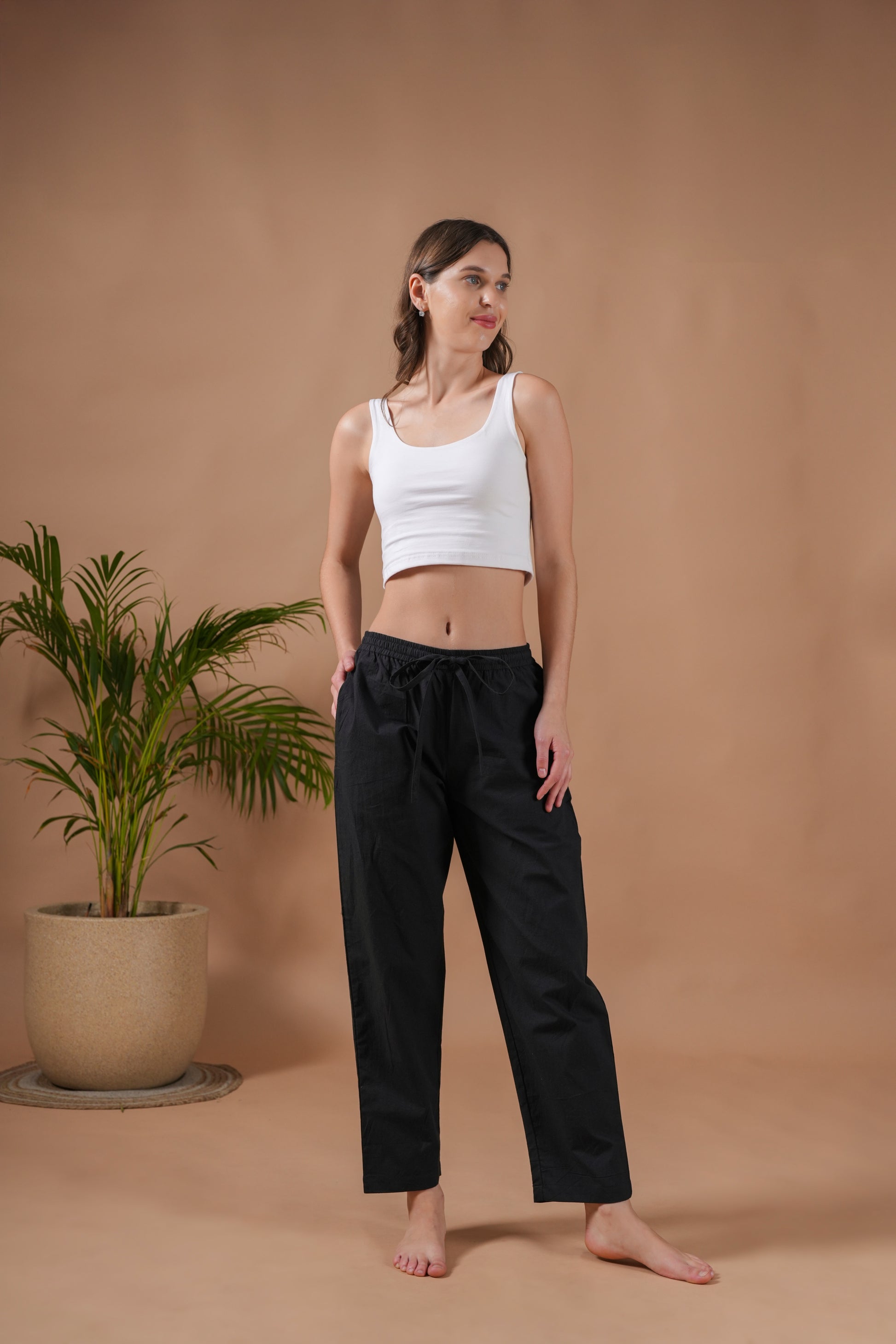 Modern and lightweight black cotton trousers for women made from poplin, featuring an elastic waistband, drawstring, and pockets—ideal for lounge & sleepwear or as stylish punk pants.