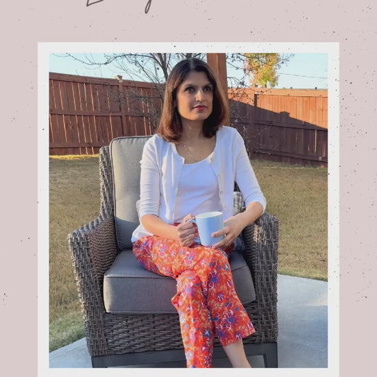 Comfortable ladies’ pajama bottoms with a cool, lightweight feel, showcasing a bold floral pattern in blue and purple on a bright orange background.