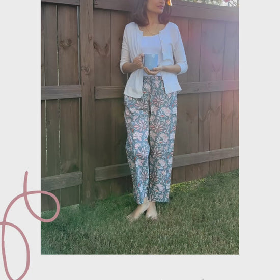 Relaxed fit cotton lounge pants for women, featuring a unique tropical orange flower print on gray, perfect for sleepwear.
