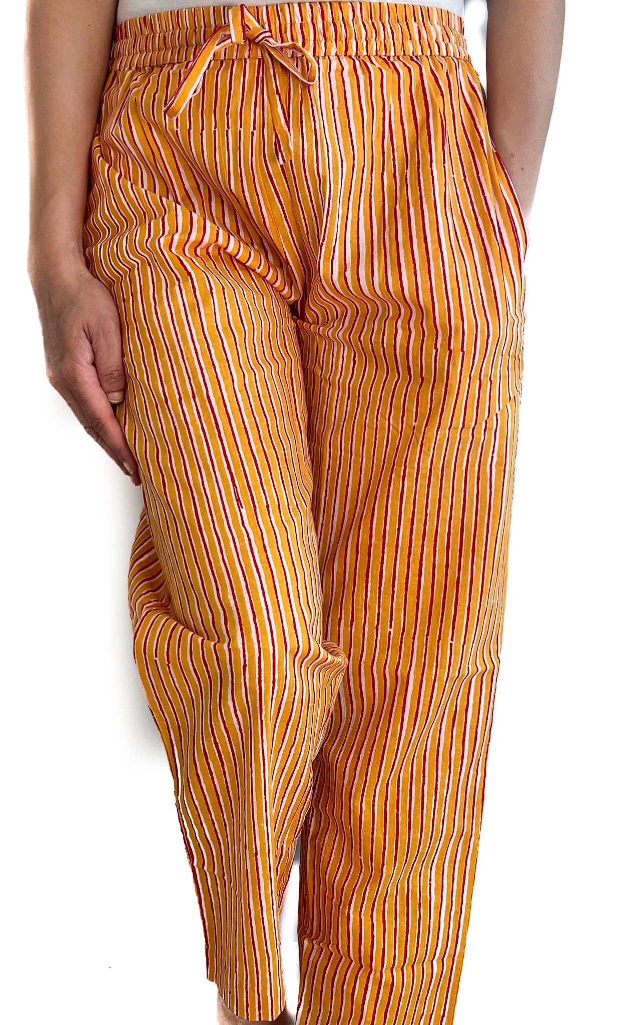 Yellow and red striped pajama pants for women, made from breathable cotton with an elastic waist and pockets