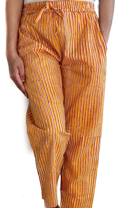 Yellow and red striped pajama pants for women, made from breathable cotton with an elastic waist and pockets