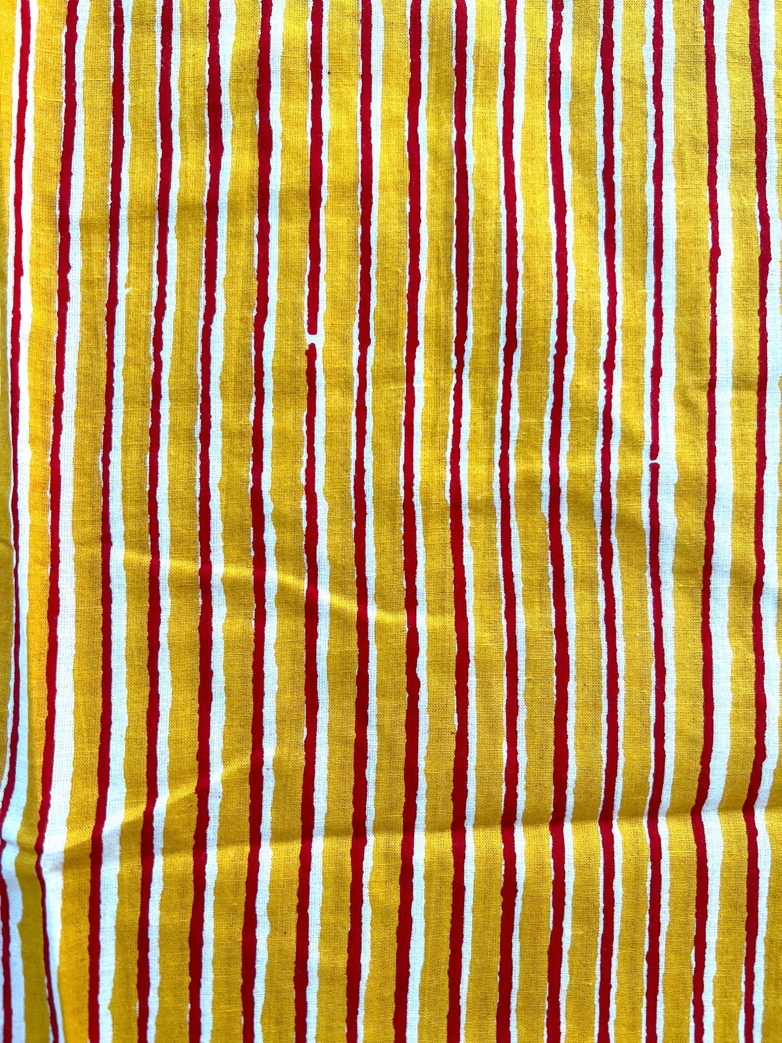 Soft and stylish women's lounge pants with an elastic waistband, pockets, and a bold yellow and red stripe design