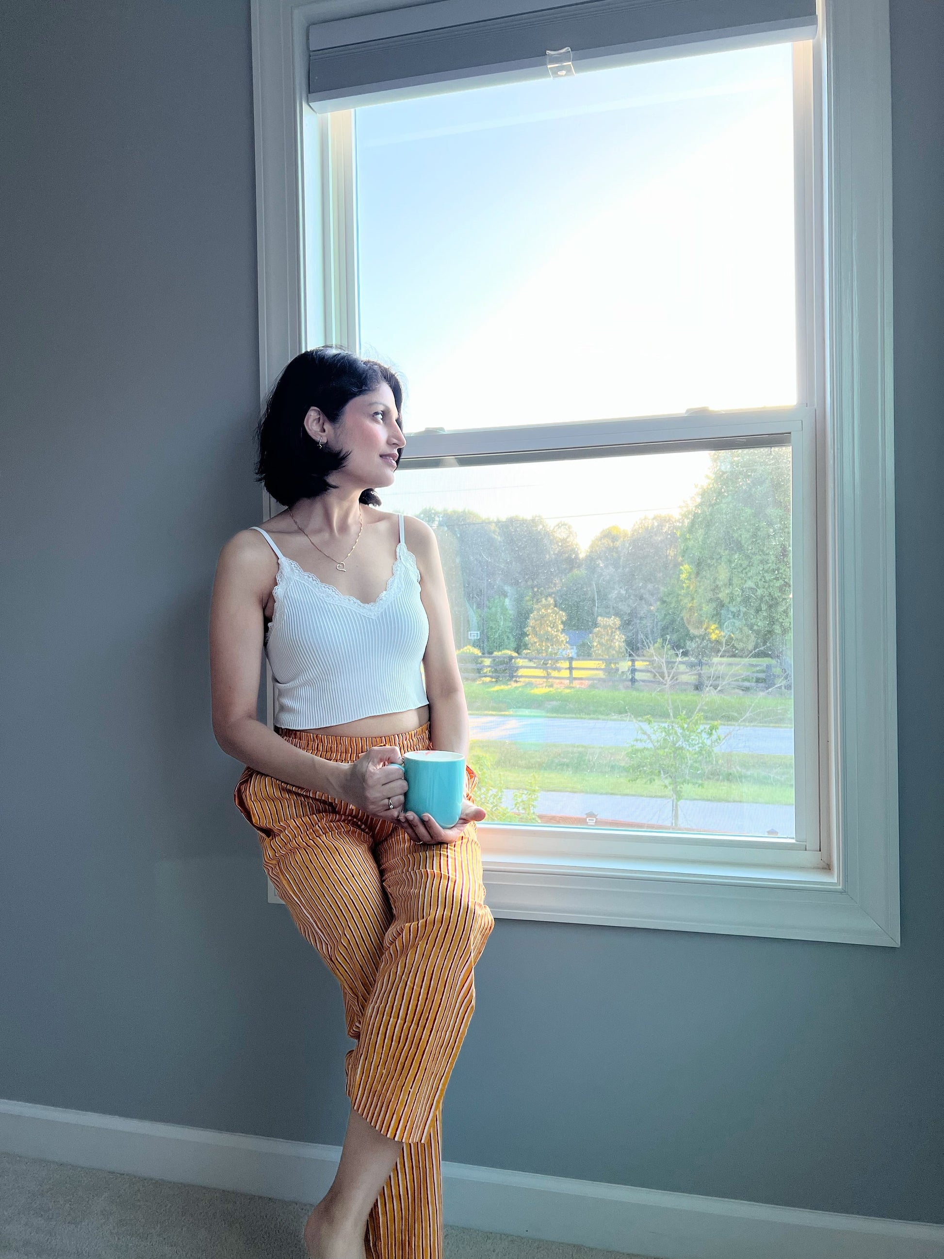 Comfortable women's pajama/lounge pants with a cheerful yellow and red striped pattern, an elastic waist, and pockets