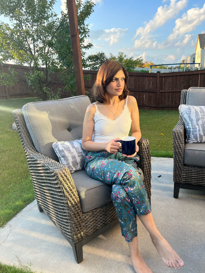 Women’s 100% cotton pajama pants with a dark blue floral print and butterflies. The pants include side pockets and an elastic waistband, making them perfect for lounging.
