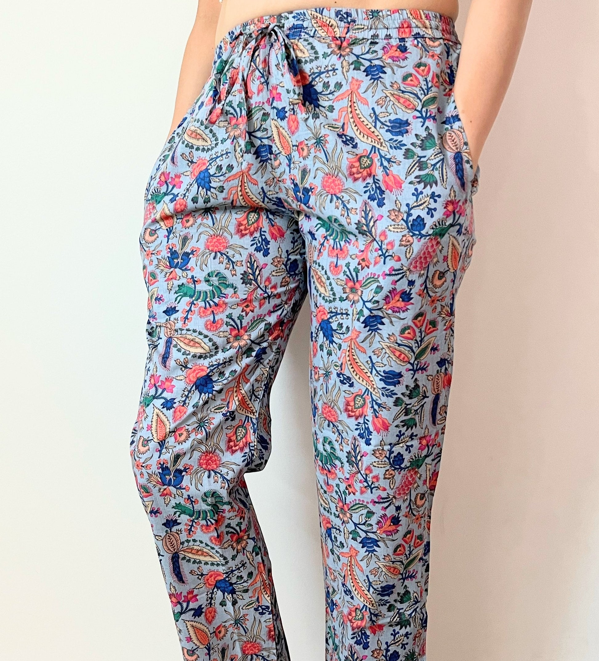 Sustainable women’s lounge pants made from eco-friendly 100% cotton, with a beautiful pink floral design on gray—lightweight, cooling, and comfy.