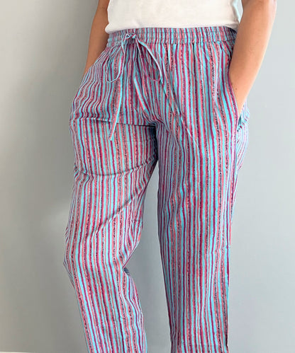100% cotton pajama trousers for women with a stylish blue and pink striped pattern. Comfortable and perfect for lounging or sleep.